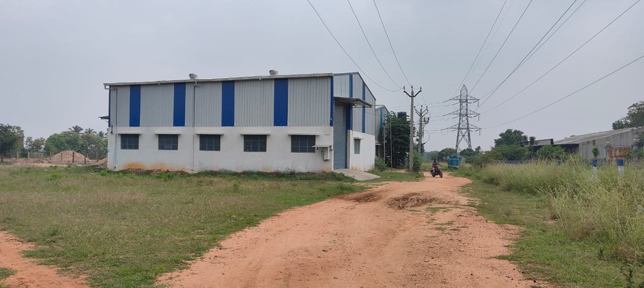 Wide angle view of industrial factory buildings with open land available for rent Coimbatore